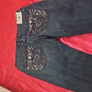 Miss me jeans with flowers on backpackets.